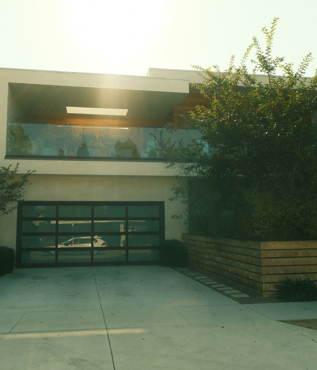 A modern home with a concrete driveway running up to the garage